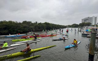 paddle crafts line up at Guanabanas in Jupiter, Florida for Tuesday Night Race League. Paddle crafts such as prone paddleboards, outrigger canoes, surf skis, Va'a and stand up paddlebaords are pictured.