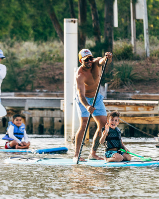 Paddleboarding in Jupiter Florida with Blueline Surf and Paddle Co. A family experience with kids on the paddleboards wearing Blueline UV Sun Shirts.