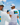 Three people on a boat wearing Blueline Bahamas Bound apparel, including Bahamas logo UV hoodies, a white graphic T-shirt, and matching performance hats while cruising over bright blue ocean water.