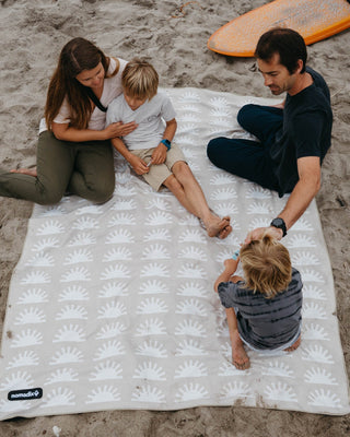 Nomadix outdoor blankets including festival blankets, blanket towels, and insulated puffer blankets designed for beach days, camping, travel, concerts, and outdoor adventures.
