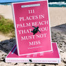Book titled “111 Places in Palm Beach That You Must Not Miss” displayed outdoors near the beach in Palm Beach County, Florida.