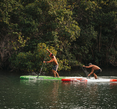 Steve Miller and Jake Portwood of Flying Fish Paddle Co. competing on the water during Blueline’s Tuesday Night Race League, a paddleboard weekly race series in Jupiter Florida. 