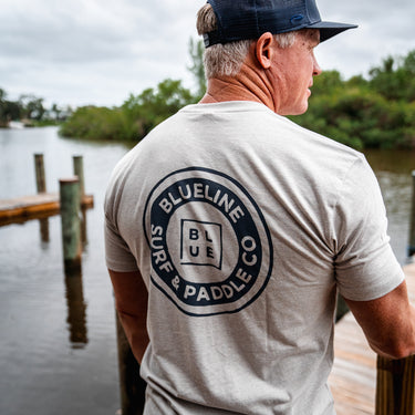 Beige t-shirt with Vintage Blueline Surf & Paddle Co logo back view looking from Guanabanas.