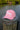 Blueline Kids Surfboard Tech Hat in Pink Heather and White displayed outdoors in Jupiter, Florida.
