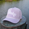 Blueline Kids Surfboard Tech Hat in Lavender and White displayed on a dock in Jupiter, Florida.