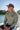 Man wearing Vintage Blueline Logo ANETIK Low Pro Tech Hoody in olive while boating in Jupiter, Florida