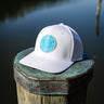 OG Blueline Logo UV Lite Hat in white with aqua patch on dock