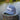 Blueline Kids Surfboard Tech Hat in slate and White displayed on a dock in Jupiter, Florida.