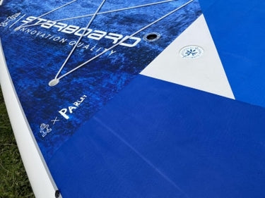 Close-up of a blue and white Starboard Go Surf SUP board.