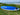 2023 Starboard Go Surf resting on green grass with a beach and ocean in the background.