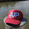 JUP burgundy trucker hat on dock by the water in Jupiter Florida