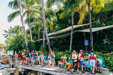 Families learning how to stand up paddle and kayak in Jupiter Florida with Blueline Surf and Paddle