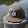 OG Blueline dark loden flat bill hat on dock in Jupiter Florida