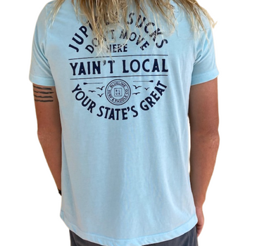 Back view of a person wearing an ice blue Blueline t-shirt with “Yain’t Local” graphic and Blueline logo printed on the back.