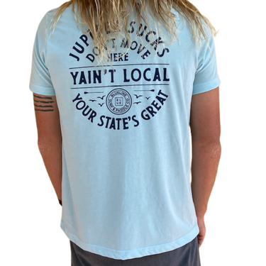 Back view of a person wearing an ice blue Blueline t-shirt with “Yain’t Local” graphic and Blueline logo printed on the back.