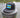Black Bahamas flag trucker hat by Blueline Surf & Paddle photographed on a weathered dock piling overlooking calm Jupiter Florida waterfront waters.