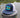 Navy and white Bahamas flag trucker hat by Blueline Surf & Paddle photographed on a dock piling overlooking the Jupiter Florida waterfront.