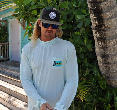 Men’s light blue Bahamas Lobster UV hooded performance shirt worn outdoors in Jupiter Florida