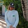 Men’s light blue Bahamas Lobster UV hooded performance shirt worn outdoors in Jupiter Florida
