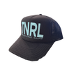 The official Blueline 2025 TNRL Foam Hat displayed at the surf shop counter in Jupiter, Florida, featuring the limited-edition Tuesday Night Race League graphic and breathable mesh backing.