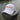 The Blueline America 250 performance hat in white featuring a clean, rope-free front profile, displayed on a weathered wood piling along the water in Jupiter, Florida.
