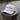 The Blueline America 250 TriTech performance rope hat in white featuring water-resistant hydrophobic fabric, a contrast front rope, and laser-perforated side panels, photographed in Jupiter, Florida.