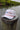 The Blueline America 250 TriTech performance rope hat in white featuring water-resistant hydrophobic fabric, a contrast front rope, and laser-perforated side panels, photographed in Jupiter, Florida.