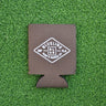 Brown neoprene Blueline diamond logo koozie with white print displayed on grass