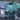 Blueline Firefly performance boardshorts in Light Blue and Camo Slate laid across a surfboard.
