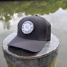 Black Blueline FlexFit performance hat featuring the embroidered Blueline Circle Logo, designed for boating, golf, paddleboarding, fishing, and outdoor adventures in Jupiter, Florida.