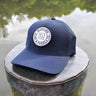 Navy Blueline FlexFit performance hat featuring the embroidered Blueline Circle Logo, designed for boating, golf, paddleboarding, fishing, and outdoor adventures in Jupiter, Florida.