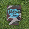 Army camo neoprene Blueline Hunt Club koozie with light blue boar hog and palmetto graphic displayed on grass