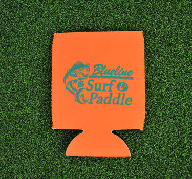 Orange neoprene Blueline jumping mahi logo koozie with aqua print displayed on grass