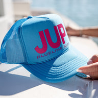 Blueline Surf JUP Foam Trucker Hat in bright blue with hot pink JUP logo and mesh back – Otto snapback cap from Jupiter, Florida surf shop.
