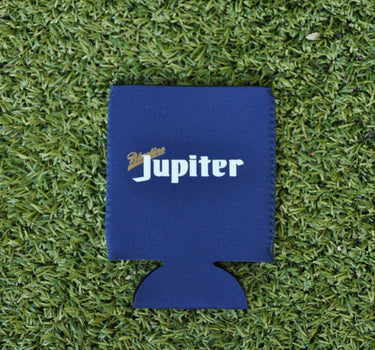 Navy neoprene Blueline Jupiter Lite koozie with light lettering displayed on grass