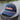 The Blueline Navy performance rope hat from the Americana Edit collection, displayed on a wooden dock piling along the Intracoastal water in Jupiter, Florida.