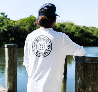 Blueline OG Circle UV Long Sleeve Sun Shirt – White / Gray, worn on a dock in Jupiter, Florida
