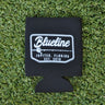 Black neoprene Blueline Rod & Reel logo koozie with white print displayed on grass