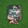 Tree camo neoprene Blueline Rod & Reel logo koozie with white print displayed on grass