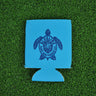 Blue neoprene Blueline turtle logo koozie with dark blue print displayed on grass