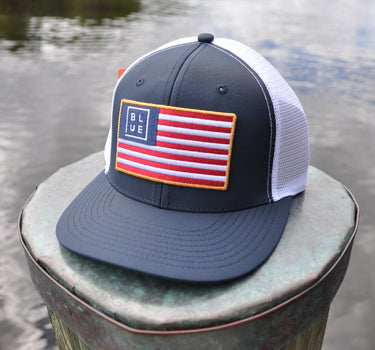 Blueline USA Flag Performance Hat in Navy and White featuring an American flag patch and lightweight performance construction.