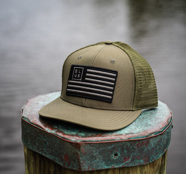 Blueline USA Flag Performance Hat in Olive featuring a blacked-out American flag patch and lightweight performance construction.