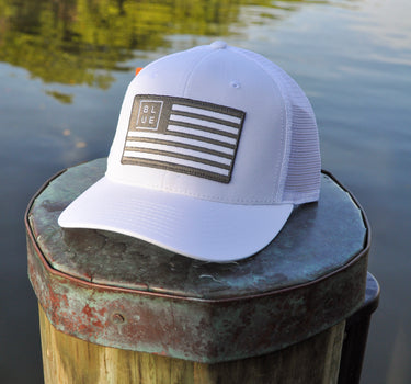 Blueline USA Flag Performance Hat in White and Charcoal featuring a tonal embroidered American flag patch with breathable perforated side panels.