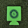 Neon green Blueline Surf & Paddle Co. neoprene koozie with navy logo on grass