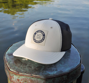 Blueline Vintage Circle Performance Hat in Stone and Navy featuring the Vintage Circle patch with breathable perforated side panels.