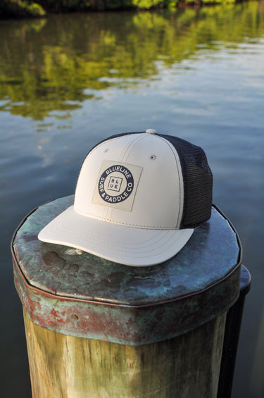 Blueline Vintage Circle Performance Hat in Stone and Navy featuring the Vintage Circle patch with breathable perforated side panels.