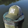 Blueline vintage circle patch trucker hat in oregano green with stone mesh photographed in Jupiter Florida