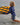 Child wearing the Blueline Youth OG Logo Hooded UV Sun Shirt in navy while carrying a skimboard into the ocean for a day at the beach in Jupiter, Florida.