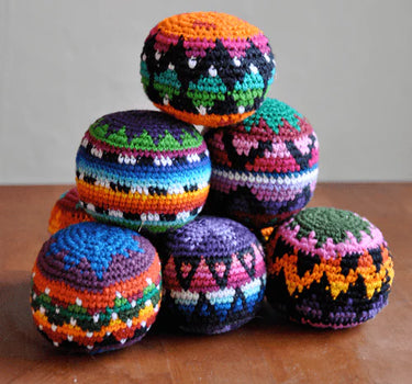 Colorful woven hacky sacks from Blueline Surf & Paddle Co. featuring assorted random patterns and coastal-inspired designs for beach days, travel, and outdoor fun.