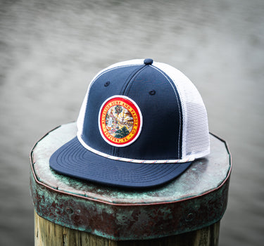 Florida Seal Performance Hat in navy and white featuring the Blueline Florida Seal patch and lightweight UV Lite performance construction.